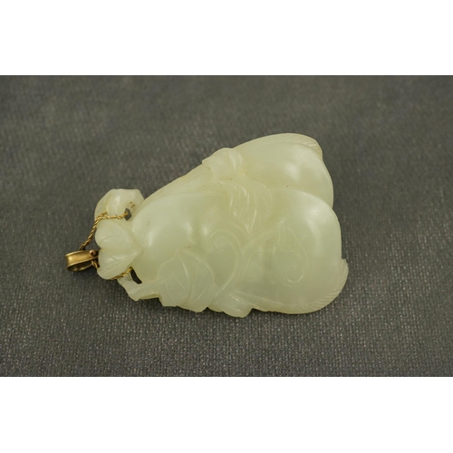 258 - A Chinese pale celadon jade twin gourd pendant, 18th century, carved in high relief and openwork wit... 