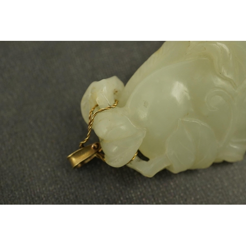 258 - A Chinese pale celadon jade twin gourd pendant, 18th century, carved in high relief and openwork wit... 