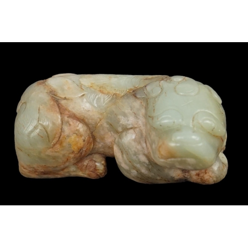 263 - A Chinese celadon and a russet jade figure of a recumbent lion-dog, 17th century, the stone with nat... 