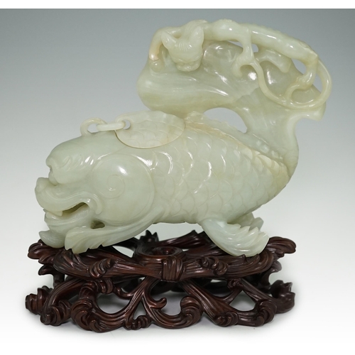 264 - A large Chinese pale celadon jade dragon-fish vessel and cover, 19th century, with a small chain-l... 