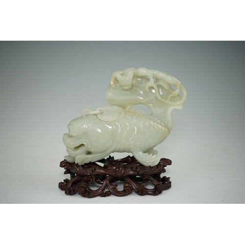 264 - A large Chinese pale celadon jade dragon-fish vessel and cover, 19th century, with a small chain-l... 