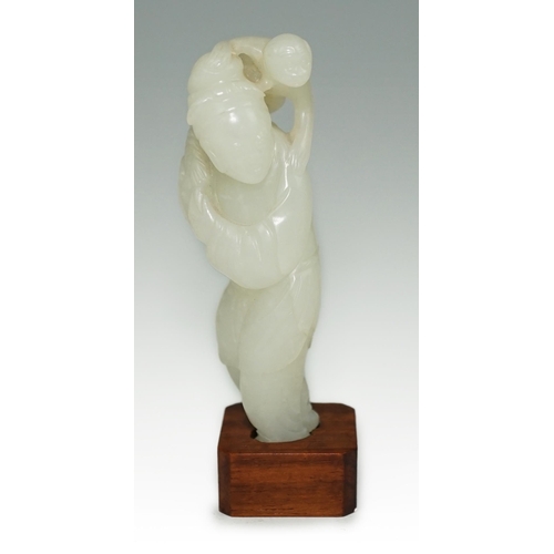 265 - A Chinese white jade figure of a monkey trainer, 18th century, the standing figure with a monkey on ... 