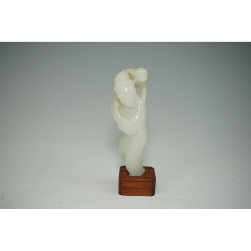 265 - A Chinese white jade figure of a monkey trainer, 18th century, the standing figure with a monkey on ... 