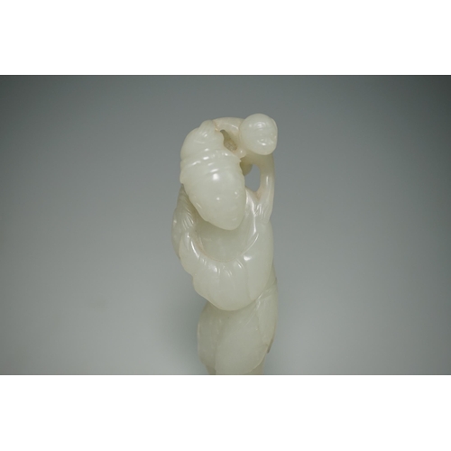 265 - A Chinese white jade figure of a monkey trainer, 18th century, the standing figure with a monkey on ... 