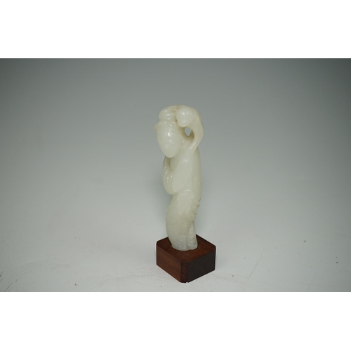 265 - A Chinese white jade figure of a monkey trainer, 18th century, the standing figure with a monkey on ... 