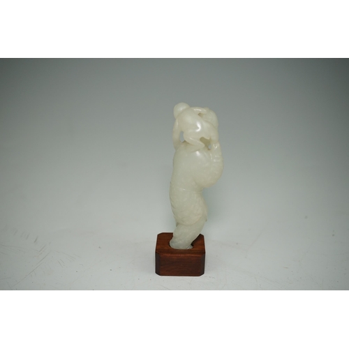 265 - A Chinese white jade figure of a monkey trainer, 18th century, the standing figure with a monkey on ... 