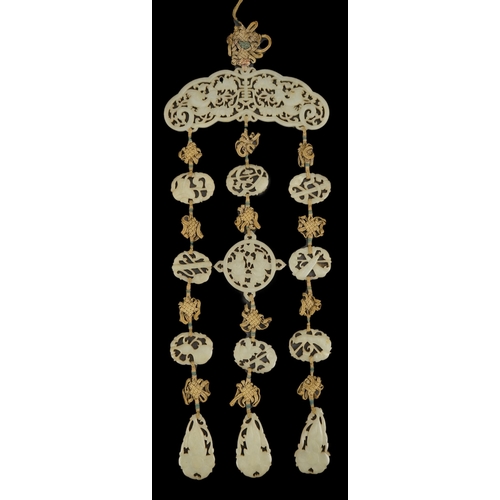 267 - A Chinese pale celadon jade Eight Daoist emblems multi-plaque wedding pendant, 19th century, the r... 