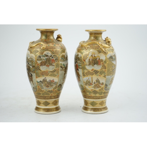 27 - A pair of Japanese Satsuma 'dragon' vases, Meiji period, each painted with samurai, ladies and rakan... 