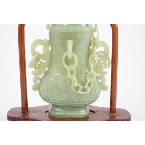 271 - A Chinese green jade vase and cover, 20th century, carved in archaistic style with pierced scrollwor... 