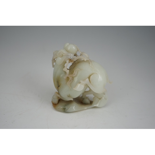 272 - A Chinese white and russet jade figure of a deer, 20th century, the galloping deer grasping a peach ... 