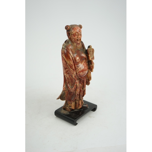 277 - A Chinese soapstone figure of the immortal Han Zhongli holding a fan, 18th century, his robes finely... 