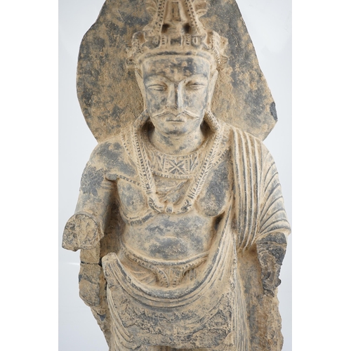 281 - A large grey schist Bodhisattva figure, Gandhara, 2nd/3rd century A.D., dressed in a flowing sangha... 