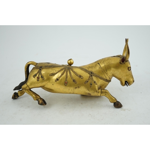 288 - A Tibetan gilt bronze figure of a buffalo, 18th century, with traces of cabochon jewelling, formerly... 