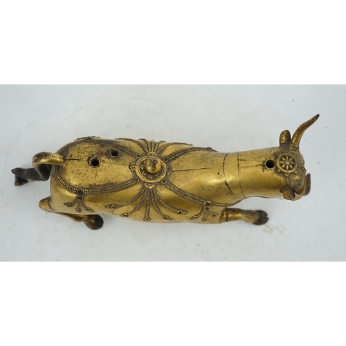 288 - A Tibetan gilt bronze figure of a buffalo, 18th century, with traces of cabochon jewelling, formerly... 