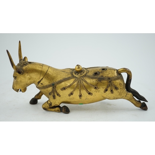 288 - A Tibetan gilt bronze figure of a buffalo, 18th century, with traces of cabochon jewelling, formerly... 