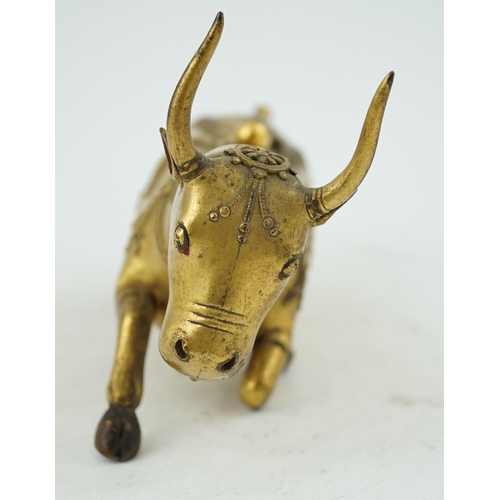 288 - A Tibetan gilt bronze figure of a buffalo, 18th century, with traces of cabochon jewelling, formerly... 