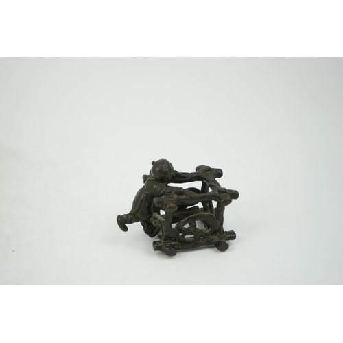 293 - A Chinese bronze figural scroll weight, late Ming, modelled as a boy standing on a wooden frame work... 