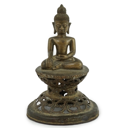 295 - An unusual Burmese bronze seated figure of Buddha, 17th/18th century, his head with unusual spiral g... 