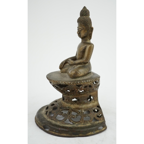 295 - An unusual Burmese bronze seated figure of Buddha, 17th/18th century, his head with unusual spiral g... 