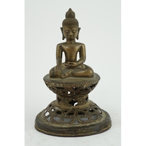 295 - An unusual Burmese bronze seated figure of Buddha, 17th/18th century, his head with unusual spiral g... 