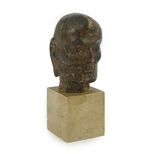 298 - A Chinese bronze model of a luohan's head, Ming dynasty, on a later stone plinth, 9cm high, total he... 