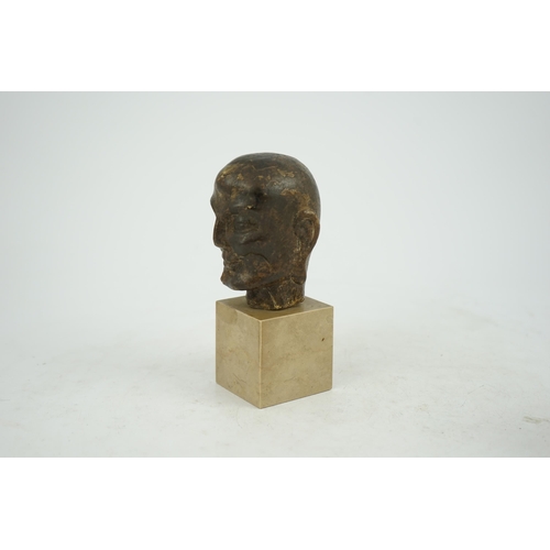 298 - A Chinese bronze model of a luohan's head, Ming dynasty, on a later stone plinth, 9cm high, total he... 