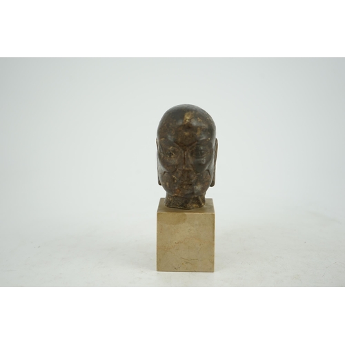 298 - A Chinese bronze model of a luohan's head, Ming dynasty, on a later stone plinth, 9cm high, total he... 