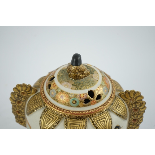 30 - the globular body applied with a pair of pierced gilt floral handles, the pierced domed cover surmou... 