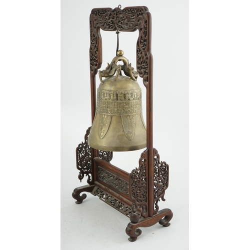 300 - A Chinese archaistic bronze temple bell, and reticulated hardwood stand, Qing dynasty, the polished ... 