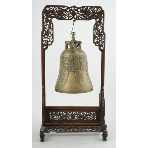 300 - A Chinese archaistic bronze temple bell, and reticulated hardwood stand, Qing dynasty, the polished ... 