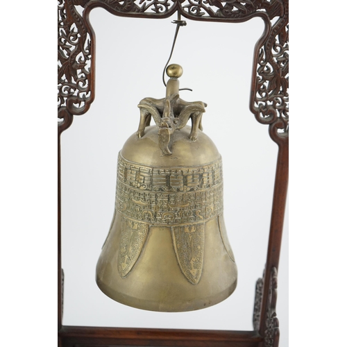 300 - A Chinese archaistic bronze temple bell, and reticulated hardwood stand, Qing dynasty, the polished ... 