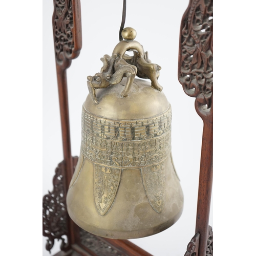 300 - A Chinese archaistic bronze temple bell, and reticulated hardwood stand, Qing dynasty, the polished ... 