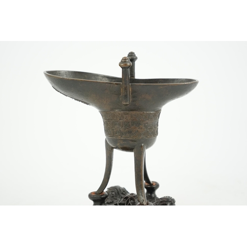 307 - A good Chinese archaistic bronze tripod wine cup, jue, dated Qianlong 3rd year, corresponding to 173... 