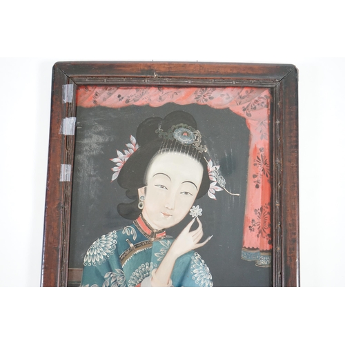 327 - A Chinese reverse painting on glass of a lady holding a flower, 19th century, image 49cm x 34cm, con... 