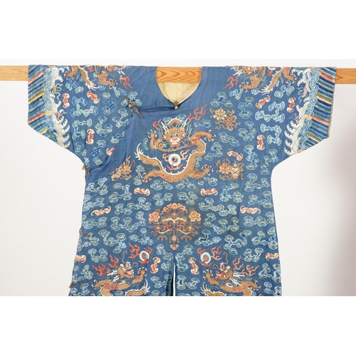 335 - A Chinese blue silk dragon robe, jifu, late 19th century and a mandarin hat, the robe woven with n... 