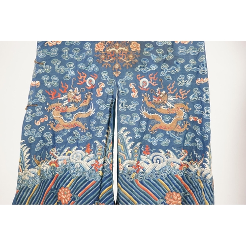 335 - A Chinese blue silk dragon robe, jifu, late 19th century and a mandarin hat, the robe woven with n... 