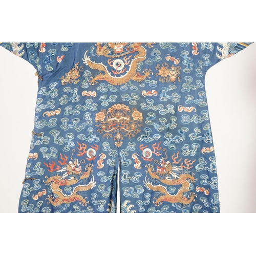 335 - A Chinese blue silk dragon robe, jifu, late 19th century and a mandarin hat, the robe woven with n... 