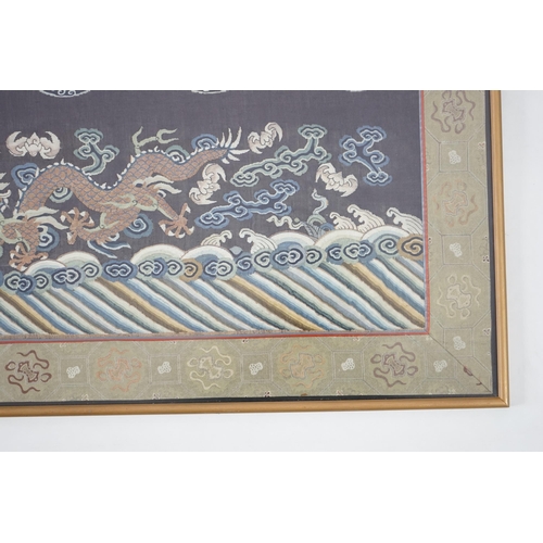 338 - A Chinese Kesi 'dragon' panel, 19th century, woven with four dragon roundels, above a five claw drag... 