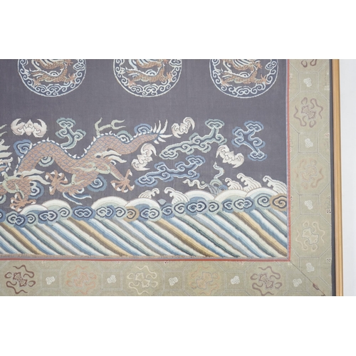 338 - A Chinese Kesi 'dragon' panel, 19th century, woven with four dragon roundels, above a five claw drag... 