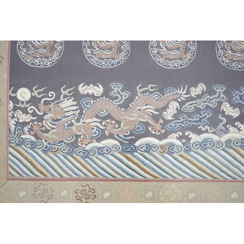 338 - A Chinese Kesi 'dragon' panel, 19th century, woven with four dragon roundels, above a five claw drag... 