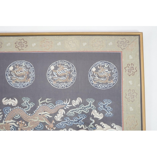 338 - A Chinese Kesi 'dragon' panel, 19th century, woven with four dragon roundels, above a five claw drag... 