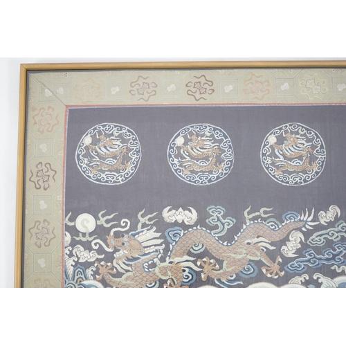 338 - A Chinese Kesi 'dragon' panel, 19th century, woven with four dragon roundels, above a five claw drag... 