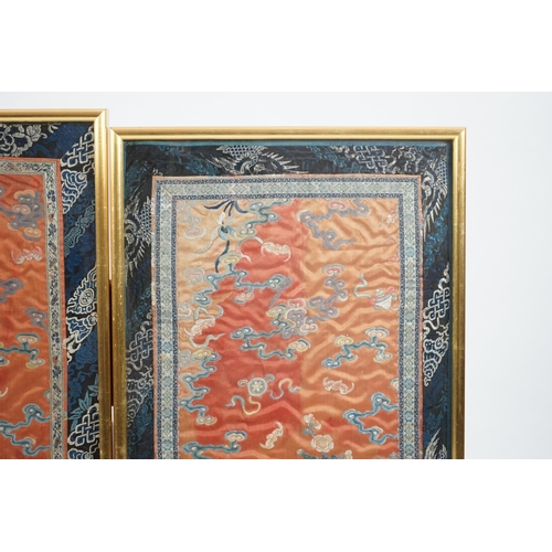 339 - A pair of Chinese coral silk dragon panels, 19th century, worked in polychrome silk and gold threa... 