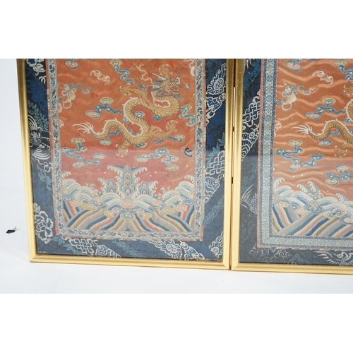 339 - A pair of Chinese coral silk dragon panels, 19th century, worked in polychrome silk and gold threa... 