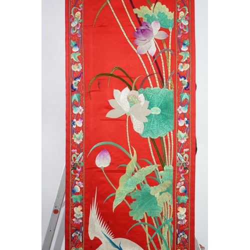 340 - A Chinese embroidered silk wall hanging, early 20th century, decorated with an egret amid lotus, on ... 