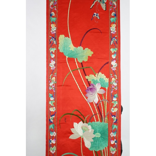 340 - A Chinese embroidered silk wall hanging, early 20th century, decorated with an egret amid lotus, on ... 