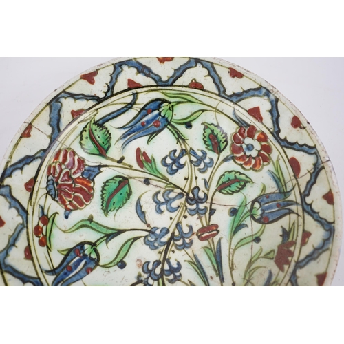 344 - An Iznik pottery dish, Ottoman Turkey, 17th century, 27cm diameter, repaired, with two books on Isla... 