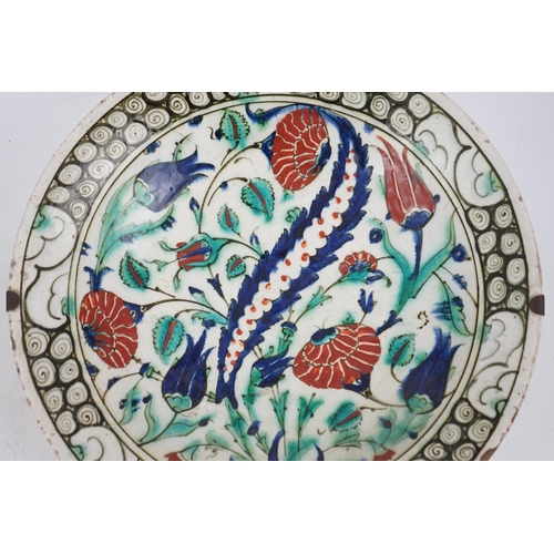 345 - An Iznik pottery dish, Ottoman Turkey, 17th century, 30.3cm diameter, with two books on Iznik cerami... 