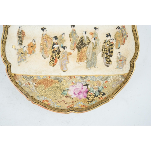 39 - A Japanese Satsuma barbed rim dish, Meiji period, painted to a rectangular reserve with a procession... 