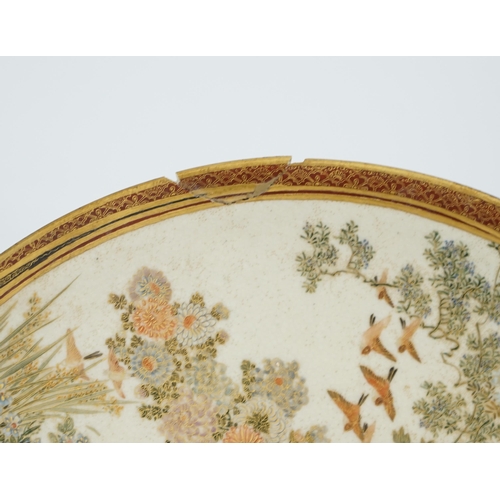 42 - A Japanese Satsuma circular dish, Meiji period, painted with ladies and children in a pavilion withi... 